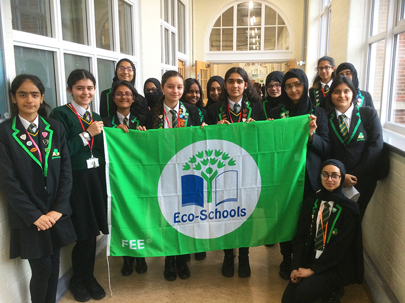 Levenshulme High School Eco Leaders present the Eco School Green Flag Award, in October 2022