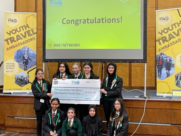 Youth Travel Ambassadors present the £500 cheque awarded for their Active Transport Project in March 2023